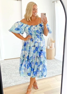 Detail of blue floral dress with off-shoulder puffy sleeves and tiered ruffle skirt design