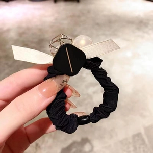 Elegante elastico per capelli nero con fiocco bianco, perla e dettagli dorati