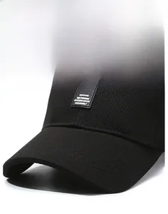 Close-up of a black golf baseball cap featuring a stiff brim and textured woven fabric