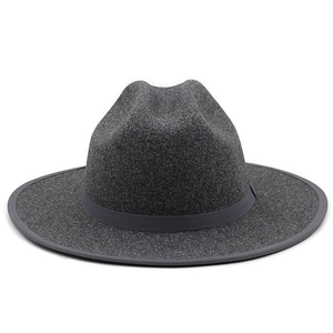 Detail of a dark gray wool fedora hat with a flat wide brim and decorative ribbon band