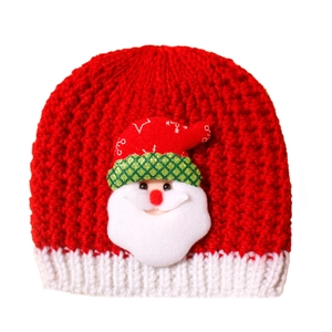 Detailed knit texture and plush Santa Claus applique on a red Christmas baby beanie