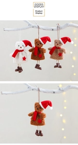 Detailed view of plush Christmas bear ornaments with red hats on festive bokeh background
