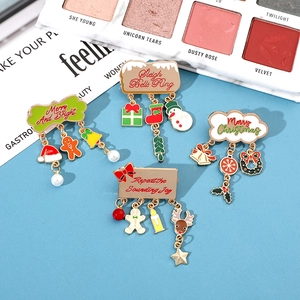 Detail of Christmas enamel pins with bells, snowmen and gingerbread charms
