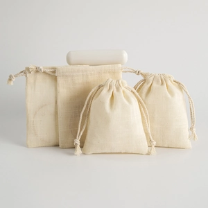 Natural cotton linen drawstring pouches in various sizes with rustic texture for jewelry