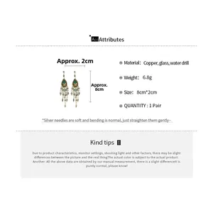 Detail view of emerald water drop tassel earrings with dimensions and material specs