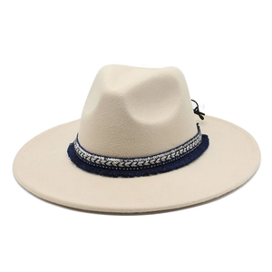 Close-up of cream wool felt jazz hat featuring blue ethnic woven band with tassels