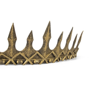 Detail of antique gold medieval crown with hammered texture and sharp spike design