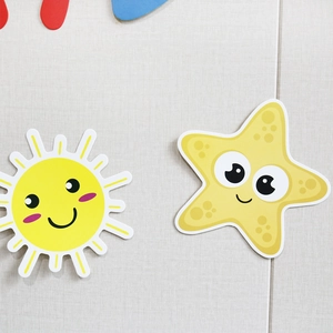 Detail of cute yellow sun and starfish paper decorations for birthday party banners