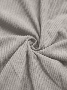 Detailed macro view of light grey corduroy fabric texture with vertical ribbed pattern