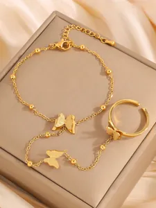 Macro shot of gold butterfly slave bracelet with frosted texture on silk background