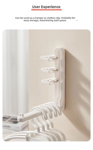 Detail of white wall-mounted folding clothes rack with non-slip hooks for home storage