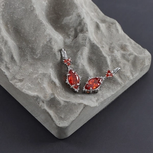Detailed macro view of red marquise-cut gems with silver metal accents on stone