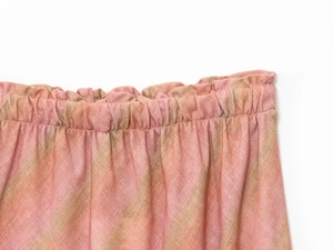Detail of elastic pleated waist on peach linen midi skirt with subtle green stripes