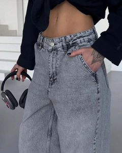 Detail of high-waist vintage grey washed jeans showing denim texture and pocket design