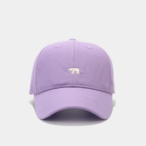 Close-up of a purple cotton baseball cap featuring small white polar bear embroidery