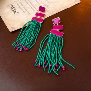Bohemian style long bead tassel earrings with green beads and magenta enamel in gold frame