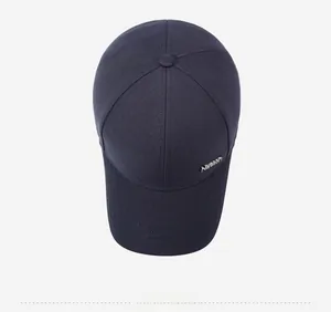 Top view of navy blue baseball cap showing crown structure and metal logo detail