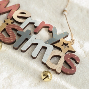 Merry Christmas wooden hanging tag with metal bells and snow-textured background