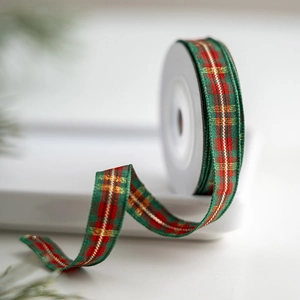 Classic green and red plaid Christmas ribbon with gold wire on a white spool roll