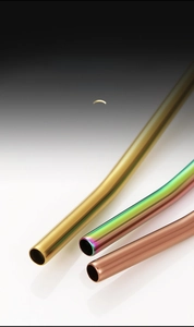Detailed macro view of the polished round nozzle on a stainless steel straw spoon