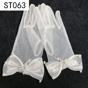 Detail of white mesh bridal gloves with satin bow and delicate faux pearl embellishments