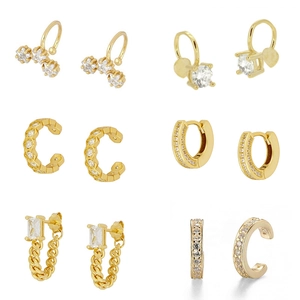 Detailansicht goldener Zirkonia-Ohrringe mit Steckern und schicken Earcuffs