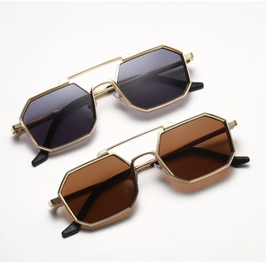 Close-up of polygon punk sunglasses with gold metal frames and double bridge design