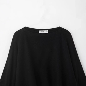 Women's black knit crop top featuring puff sleeves and boat neckline in a relaxed fit