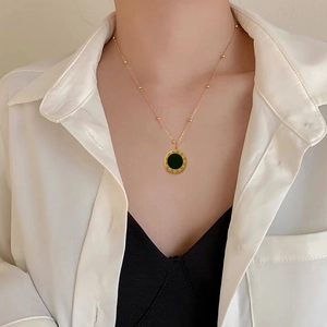 Minimalist titanium steel gold necklace with Roman numerals and black shell pendant on model