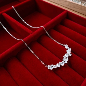 Minimalist silver chain necklace with teardrop zircon on dark red velvet gift box