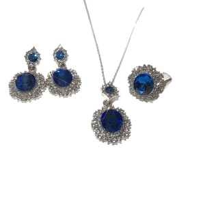 Vintage silver jewelry set with oval blue gemstones and white diamond accents on necklace