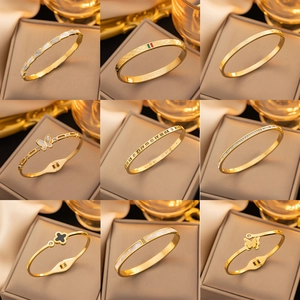 Luxury gold titanium steel bracelet set featuring mother of pearl and crystal accents