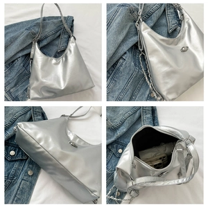 Detail view of silver PU leather hobo bag with chain strap and spacious interior storage