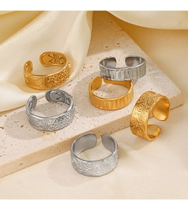 Detailed view of adjustable stainless steel eye rings in gold and silver on stone
