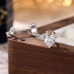 Elegant S925 sterling silver heart earrings with sparkling cubic zirconia on wood base