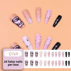 Detail of pink French press-on nails with Lose sus lettering and rhinestone accents
