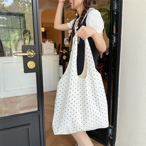Detailed view of polka dot canvas tote bag with wide straps for everyday casual use