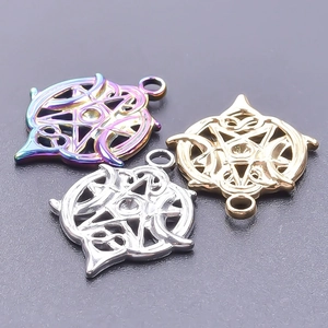 Macro detail of three Celtic star pendants in gold, silver, and rainbow steel finishes