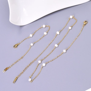 Detail of gold lobster clasp and extension chain with K18 engraving on pearl jewelry