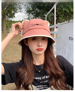 Detailed embroidery of cat whiskers and 3D ears on a pink cotton bucket hat