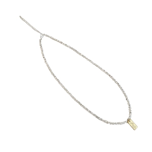 Sparkling silver beaded necklace with rectangular gold pendant and adjustable chain link