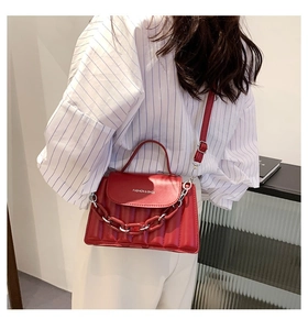 Close-up of red quilted PU leather crossbody bag with chain and Fashion & Bags text