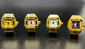 Detailed set of four square gold ring watches with colored dials on a black background