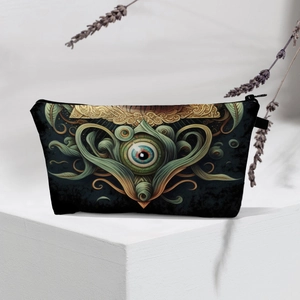 Close-up of waterproof cosmetic bag featuring green and gold evil eye pattern on white base