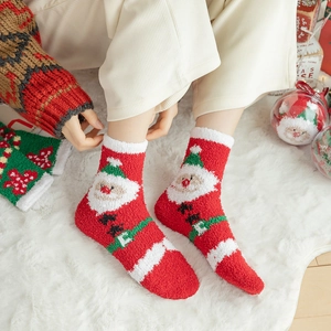 Soft coral fleece Christmas socks featuring red and white Santa Claus holiday pattern