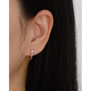 Close-up of minimalist S925 silver hoop earring with opal inlay worn on an ear