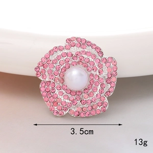 Detailed close-up of pink rhinestone camellia charm with a central pearl, 3.5cm size