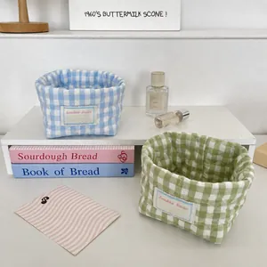 Detailed view of quilted cotton storage baskets with blue and green checkered patterns