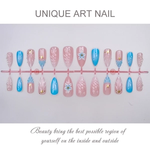 Detail of 3D flower and gold star charms on pink and blue press-on nails with wave texture