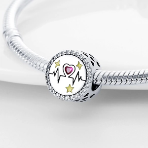 Macro view of silver heart rate charm with red heart gem and clear cubic zirconia stones